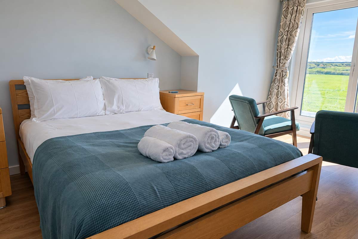 Guest-ready holiday let bedroom with fresh towels in Weymouth